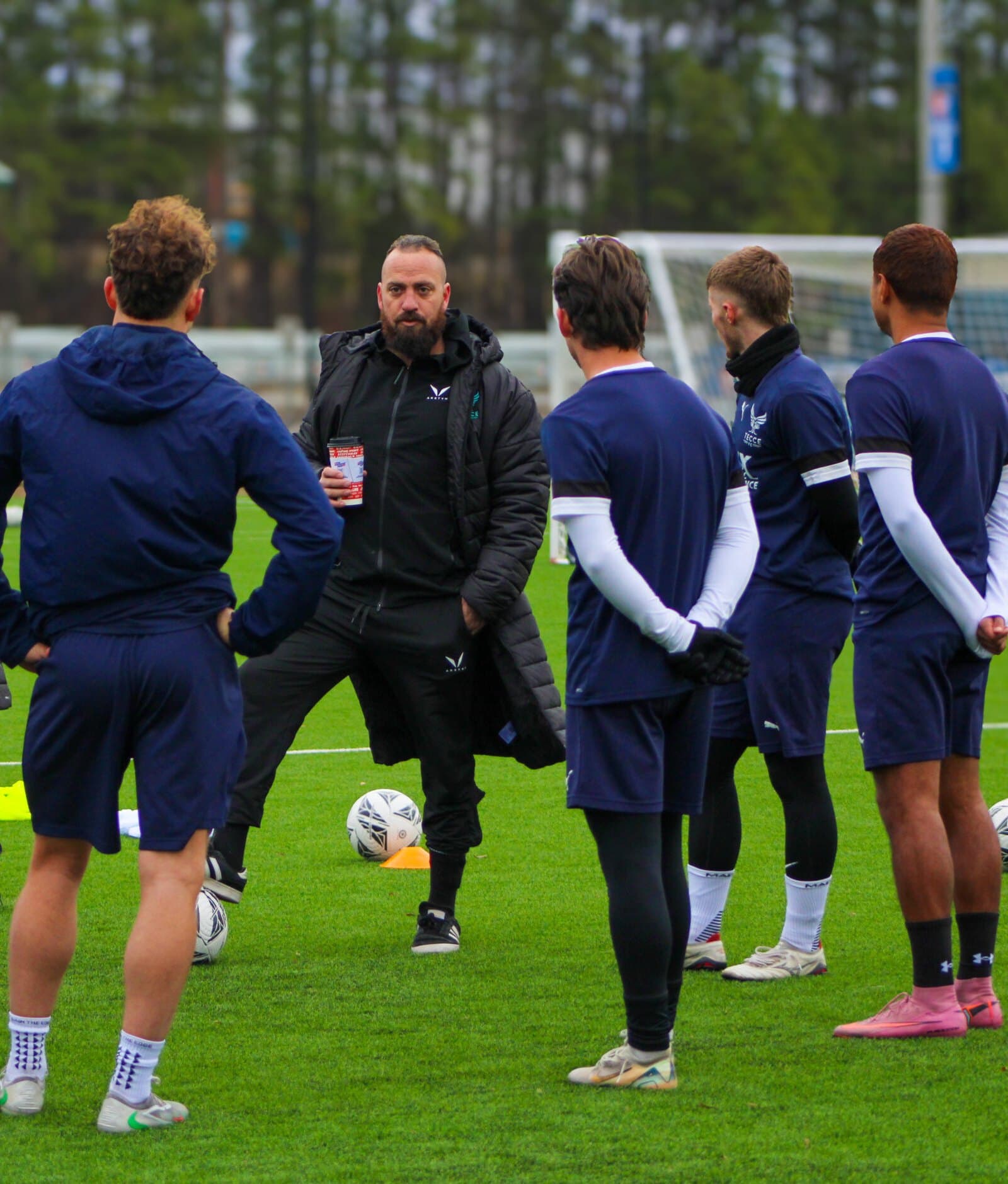TECCE coach talking with players at training